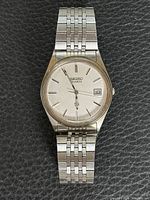 Front view of Seiko quartz watch showing dial and bracelet