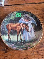 Front of decorative plate showing angel and foal artwork
