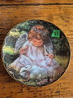 Front of porcelain plate showing angel and lamb artwork