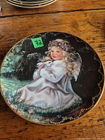 Front of plate showing angel artwork and gold rim