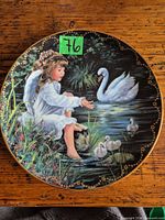 Front of porcelain collector plate showing artwork and gold rim