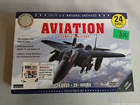 Front of sealed DVD box showing title, jet image, 24 DVDs, 28+ hours, bonus CD note, collector's set label