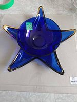 Round blue glass bowl nested inside star-shaped dish