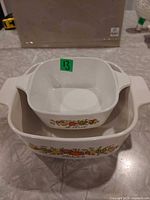 Both CorningWare bowls stacked to show relative sizes and condition