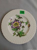 Front view of the Cauldon china plate showing beaded rim and purple floral decoration