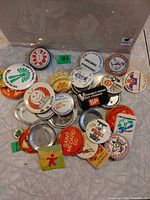 Top view of pile of assorted French language buttons