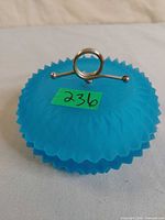 Lidded vanity dish showing diamond point pattern and metal ring finial