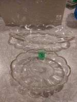 Both clear scalloped oval glass dishes viewed top