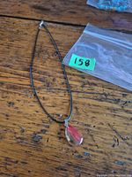 Full view of necklace showing pendant and cord