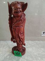 Full view of carved hardwood Happy Buddha statue