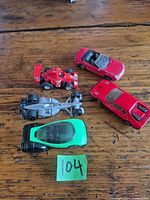 All five die-cast cars grouped on tabletop