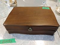 Closed wooden jewelry box showing exterior shape and clasp