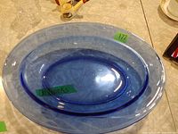 Top view of oval blue glass bowl showing interior feather pattern