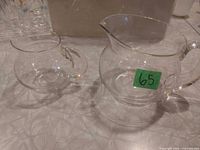 milk jug and creamer side by side on counter