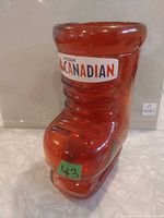 Front angled view of red Molson Canadian skate-shaped beer mug
