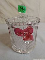 Front view of crystal jar showing spiral ribs, lid, red painted flowers