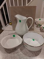 Group shot of ceramic pitcher, pie dish and enamel bowl