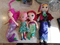 All four plush dolls laid out side by side