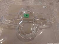 Top view of three-compartment pressed glass cloverleaf dish