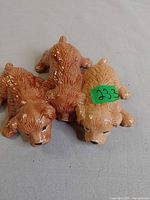 Top view of ceramic figurine showing three puppies