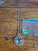 Full view of necklace with pendant laid flat on table