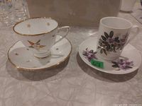 Royal Stafford star-pattern teacup with saucer beside Hertel Jacob floral teacup with saucer