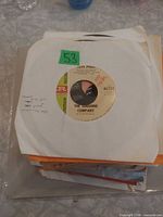 Stack of 45 rpm records showing The Sunshine Company single on top