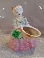 front view of ceramic lady planter showing bowl opening and colors