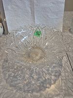Top view of clear pressed glass bowl showing starburst pattern and scalloped rim