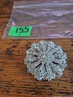 Front view of circular rhinestone brooch