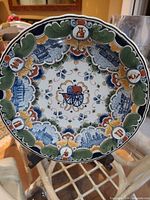 Front view of multicolour commemorative porcelain plate on stand