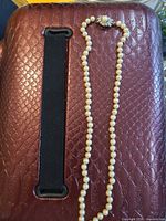 Full view of pearl necklace showing length and detached clasp