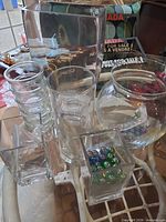 Assorted clear glass vases, marbles inside vases