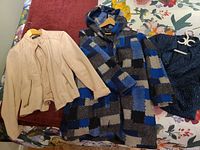 Overview of all three jackets laid out on bed