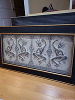 Front view of framed Thai-inspired relief artwork