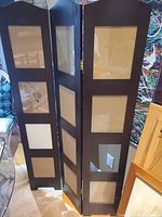 Full view of three-panel espresso laminate room divider showing photo openings