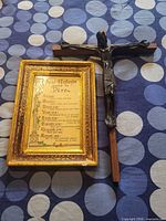 Framed French print and metal crucifix on wooden cross