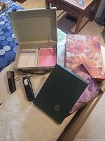 All items laid out including decorative boxes, staplers and document box
