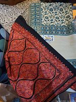 Two throws overlapping: Egyptian cotton floral and Peruvian pashmina edge