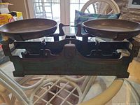 Full view of balance scale with both pans attached