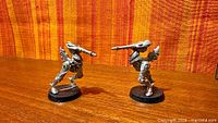Two unpainted Eldar miniatures, frontal view