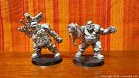 Front view of both unpainted metal Ogryn figures on bases