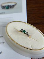 Ring on oval display showing stone layout and metal colours