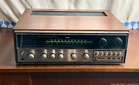 Front angled view of Kenwood KR-7200 showing full unit and cabinet