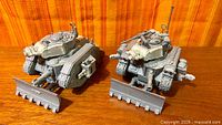 Front view of two assembled Leman Russ tanks with dozer blades