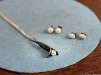 Necklace and both earring pairs overview on felt mat