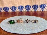 Four sterling silver rings laid out front view