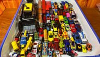 Tray filled with assorted die-cast cars and trucks