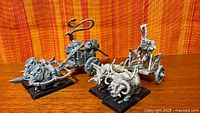 Two assembled unpainted Skaven chariot conversions side by side on bases