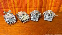 Four assembled Predator tank miniatures lined up